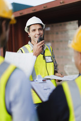 Workers talking in shipping yard