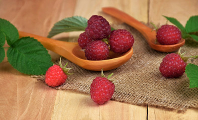 Ripe raspberries in a wooden spoon. Natural vitamins. Natural treatment.