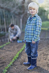 Boy gardening with father