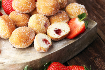 Bomboloni - traditional Italian doughnuts stuffed with strawberry jam