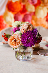 flowers in the vase on the banquet table