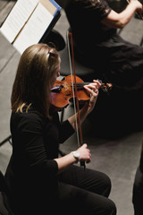 Violin player in orchestra © Image Source RF
