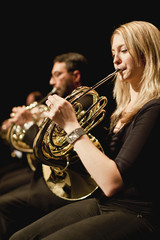 French horn players in orchestra © Image Source RF