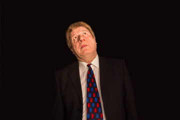 Closeup portrait, senior mature man, daydreaming about something that makes him happy, looking up