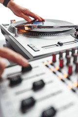 a person using a turntable and mixing board.