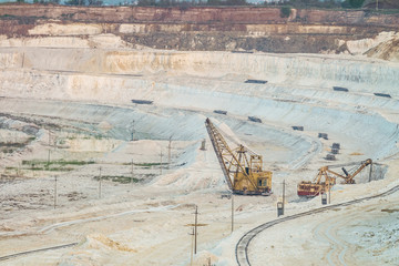 Work of heavy grab excavators in the chalk quarry. Heavy mining industry. Clamshell excavators in...