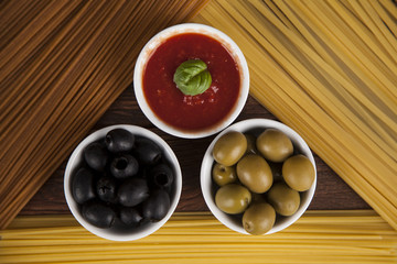 Dry pasta with ingredients on a old wood