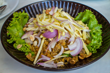 Crispy catfish spicy salad with green mango, Thai food,Crispy catfish salad with green mango and vegetable