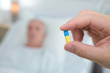 presenting a pill to patient