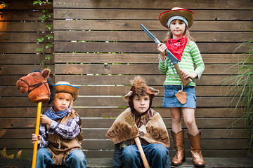 Children dressed up as cowgirl, bear and cowboy