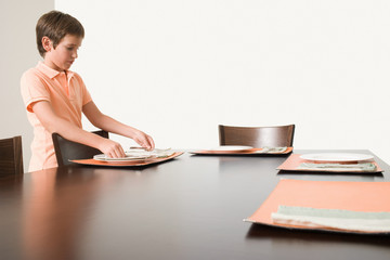 Boy setting the table