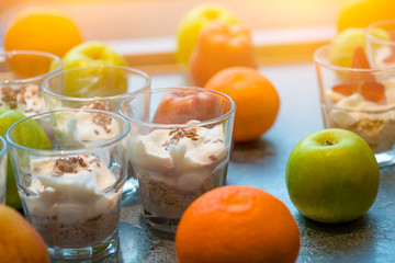Healthy breakfast with muesli in glass and fruits