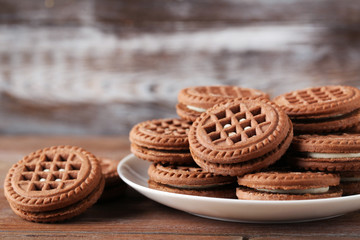 Chocolate cookies with cream on brown wooden table
