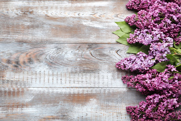 Branch of lilac flowers on wooden table