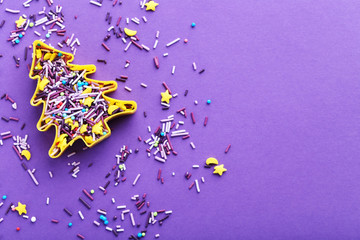 Colorful sprinkles on a purple background