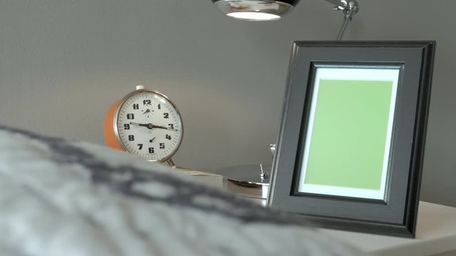 Picture photo frame with green screen, next to bed