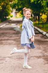 Positive little girl. Fancy Hairstyle. Sincere smile. summer weather