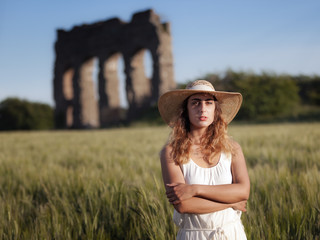 Girl in wheat field, ancient ruin, backlight