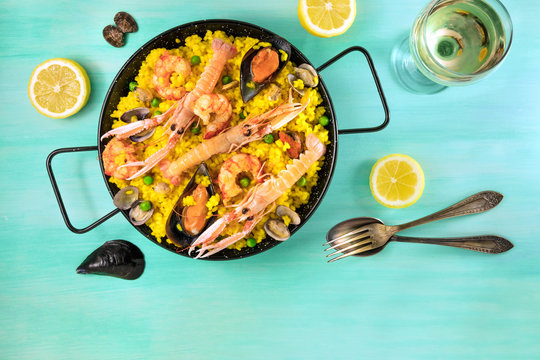 Spanish seafood paella with white wine and copyspace
