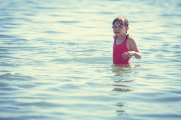 Little girl kid in sea water. Fun