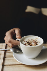 young man with a cup of cappuccino