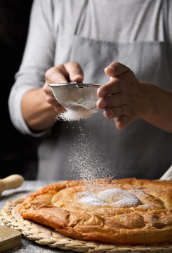man preparing ensaimada typical of Mallorca, Spain