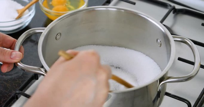 Melting sugar for caramel sauce. Chef preparing caramel in the pan. Boil sugar. The technical process of preparation of caramel. Shot 4K footage at 10 bit.