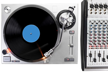 a turntable and mixing board in a recording studio