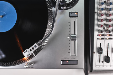 a turntable and mixing board in a recording studio