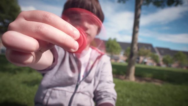 4k Child Having Fun Outdoors with Fidget Spinner