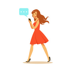 Young woman walking and sending a message to someone using her smartphone