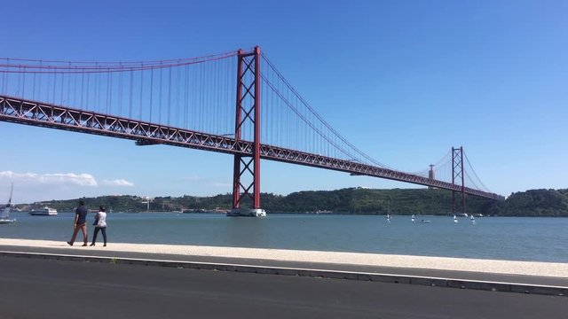 Walking Along Famous Lisbon Landmarks, Suspension Bridge In Tagus River. Lisbon is the capital and the largest city of Portugal