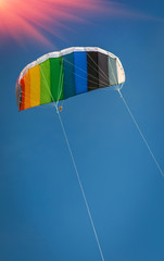 Kite rainbow colors fly high in the sky