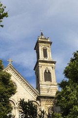 Old church among the green trees with blue sky