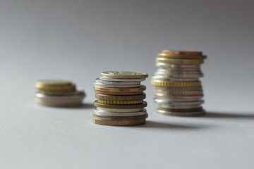 Stacks of coins on gray background.