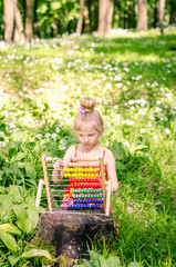beautiful girl with abacus in the forest