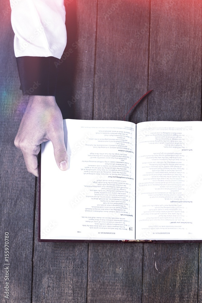 Wall mural Woman holding bible