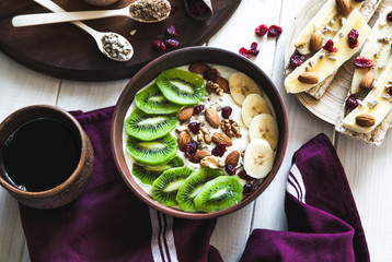 Yogurt with different fruits on a wooden background. Useful food, diet, organic.