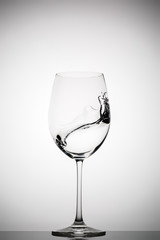 wineglass with splashing liquid