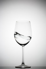 wineglass with splashing liquid