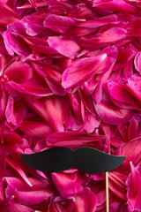 Hipster fake mustache on blossom background.