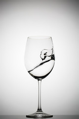 wineglass with splashing liquid