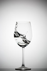 wineglass with splashing liquid
