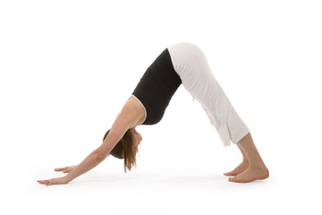 Studio shot over a white background of a healthy, attractive young woman practicing yoga exercise.