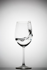 wineglass with splashing liquid