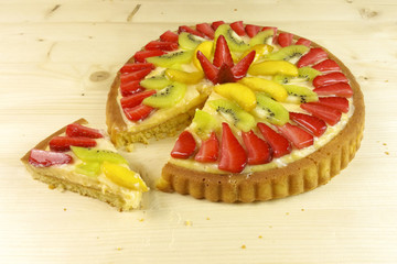 Fruit tart on wooden background - top view