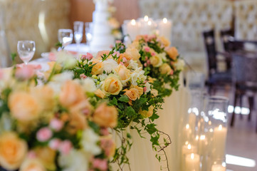 wedding flower arrangement on the background of burning candles