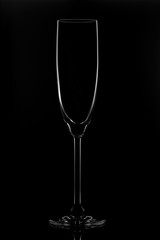 Transparent glass for wine on a black background.