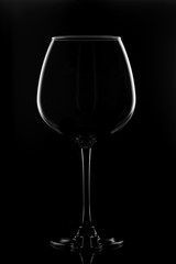 Transparent glass for wine on a black background.