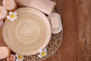 Obraz na płótnie Canvas Beautiful spa composition of plate and candles on wooden background